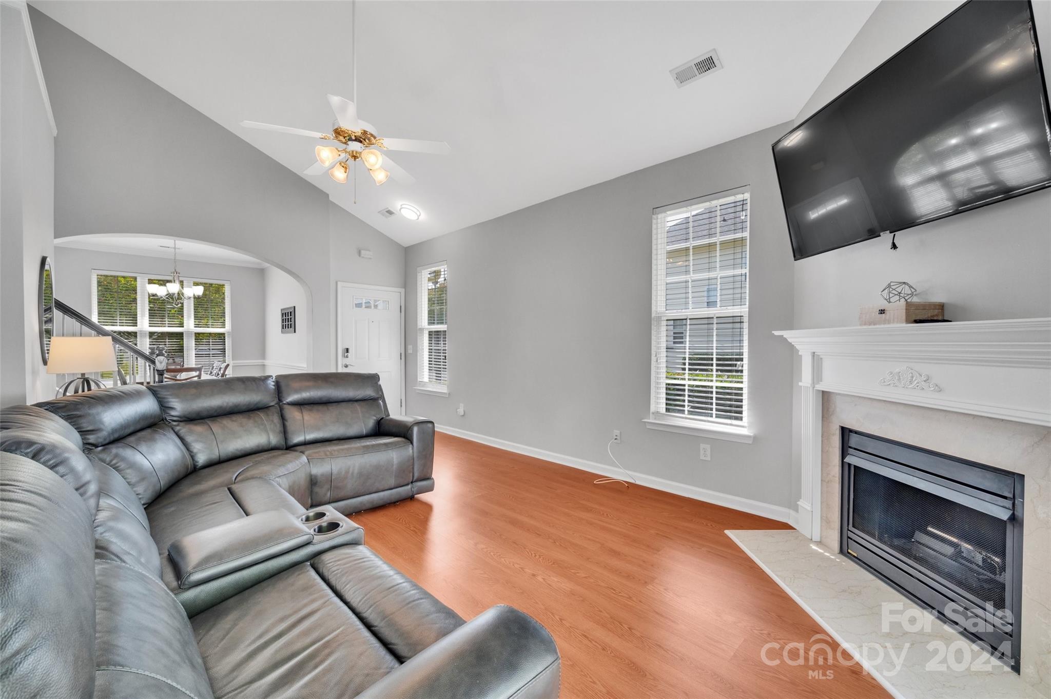714 Shellstone Place Fort Mill, SC 29708 - Photo 9 of 24 a living room with furniture a fireplace and a flat screen tv