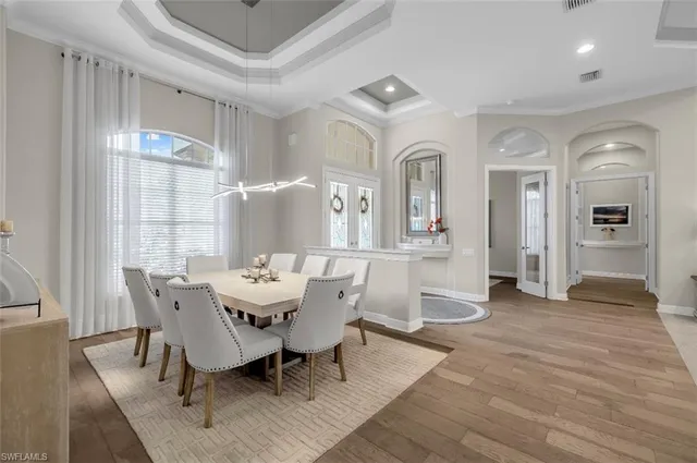 an open kitchen with stainless steel appliances kitchen island granite countertop a lot of cabinets and wooden floor