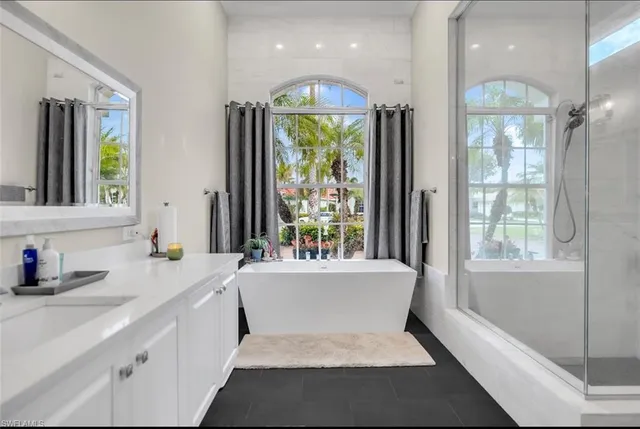 a bedroom with a large bed and a large window