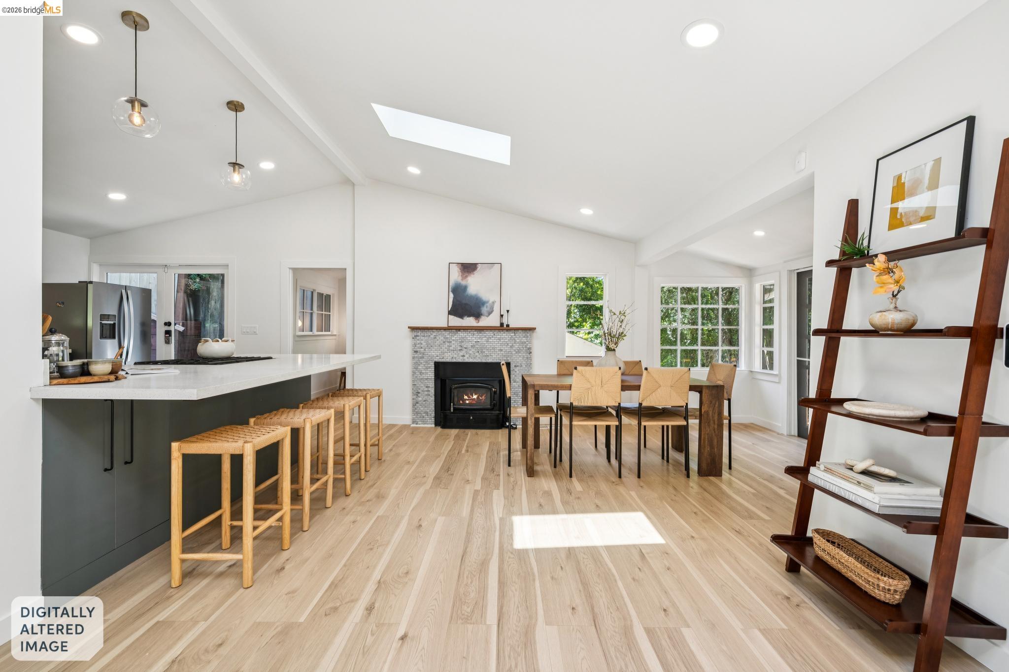 6400 Pinehaven Road Oakland, CA 94611 - Photo 14 of 78 Open-concept living area featuring light wood-finish flooring, vaulted ceilings, and a skylight