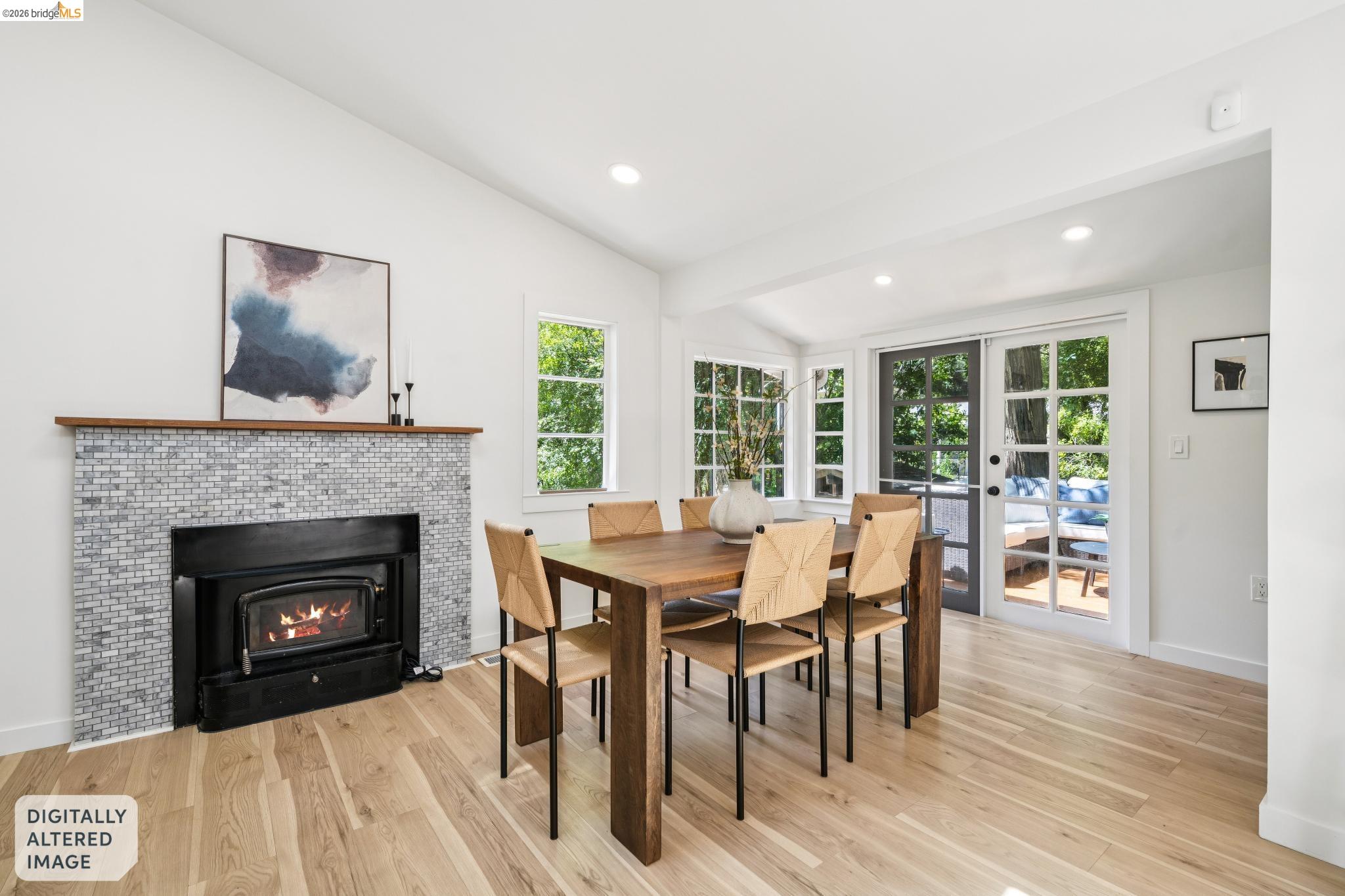 6400 Pinehaven Road Oakland, CA 94611 - Photo 16 of 78 Dining area featuring light wood-finish flooring and a fireplace with a mosaic tile surround and wood mantel