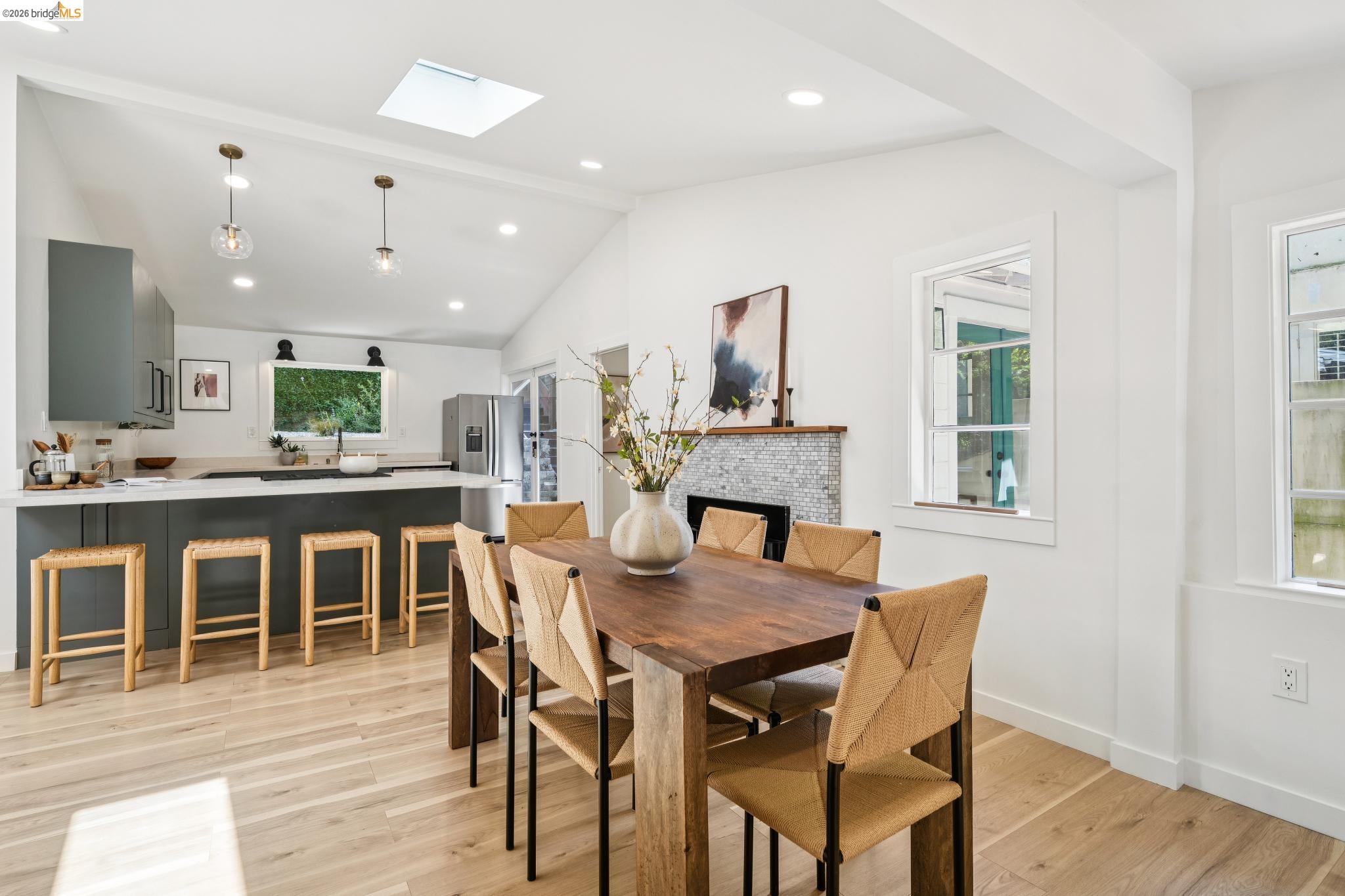 6400 Pinehaven Road Oakland, CA 94611 - Photo 21 of 78 Open-concept living space with vaulted ceilings featuring wood-finish flooring