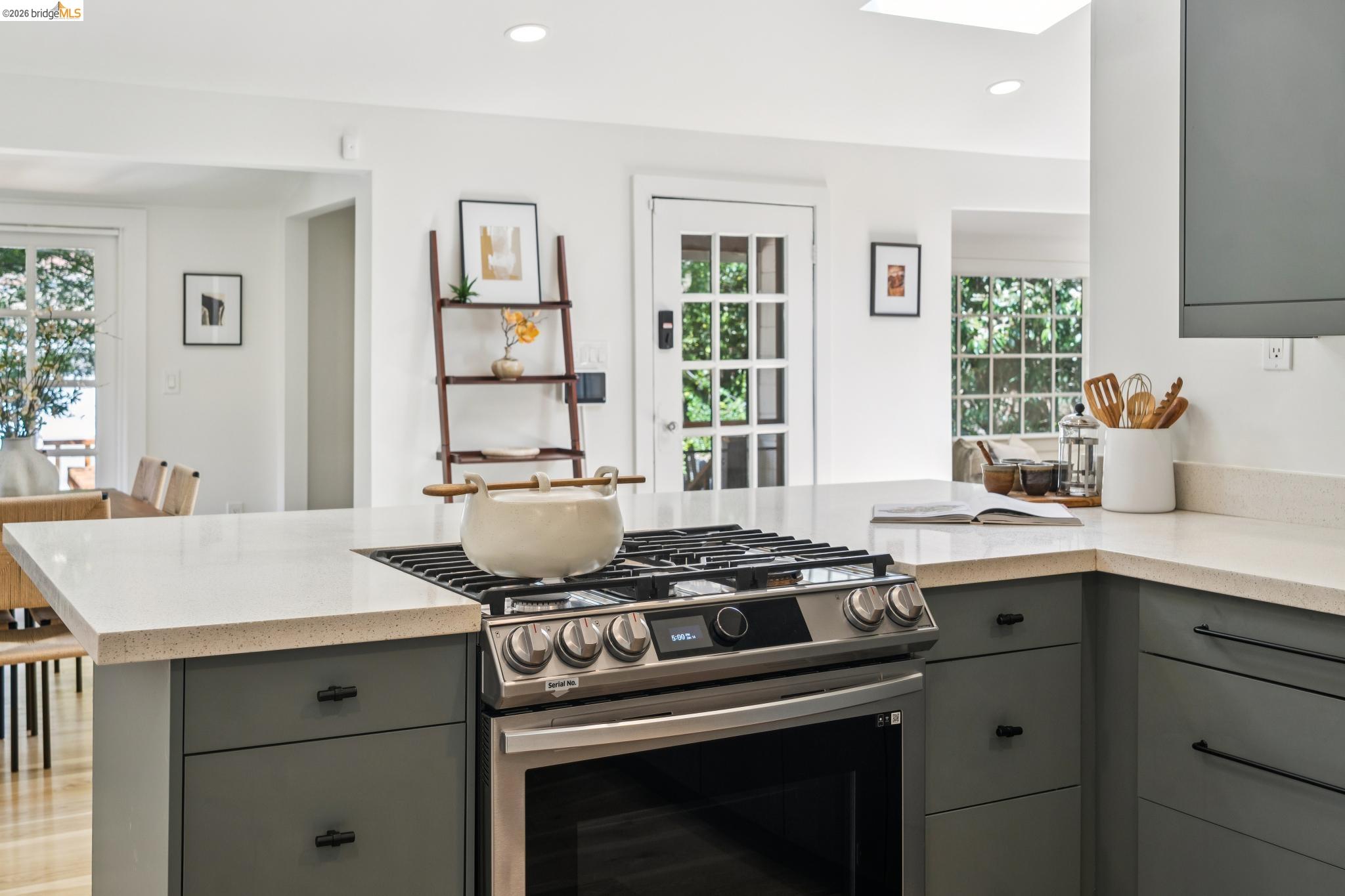 6400 Pinehaven Road Oakland, CA 94611 - Photo 28 of 78 Kitchen featuring light-toned countertops, a stainless steel range with gas burners, recessed lighting, and a skylight