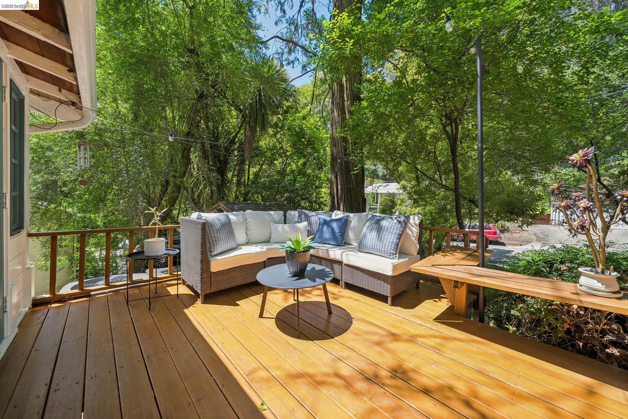 6400 Pinehaven Road Oakland, CA 94611 - Photo 31 of 78 Expansive outdoor deck featuring wood flooring, a natural wood railing, and surrounding mature trees
