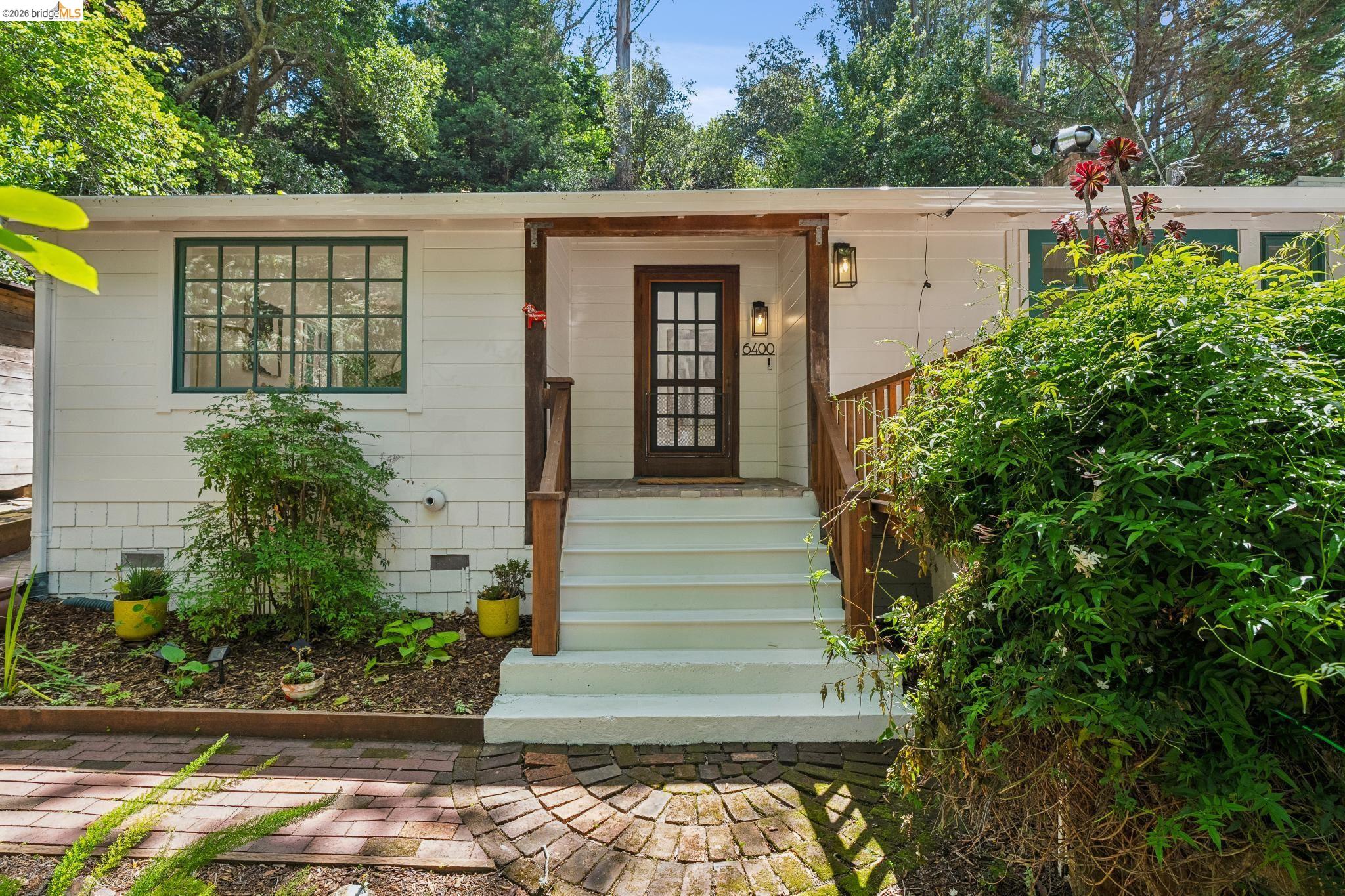 6400 Pinehaven Road Oakland, CA 94611 - Photo 4 of 78 White exterior with wood-finish porch columns and railings