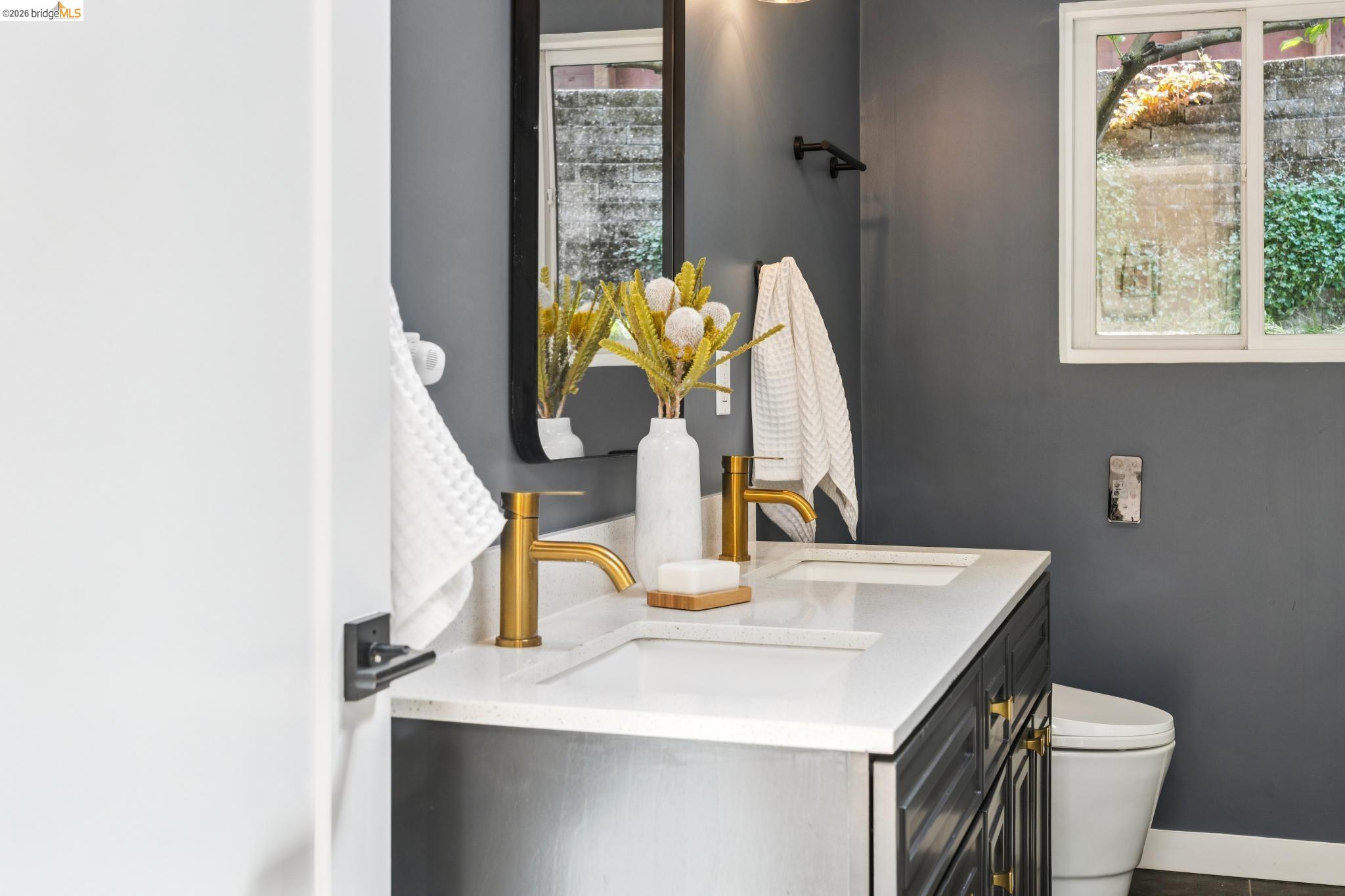 6400 Pinehaven Road Oakland, CA 94611 - Photo 42 of 78 Double vanity with white countertop and gold-finish fixtures