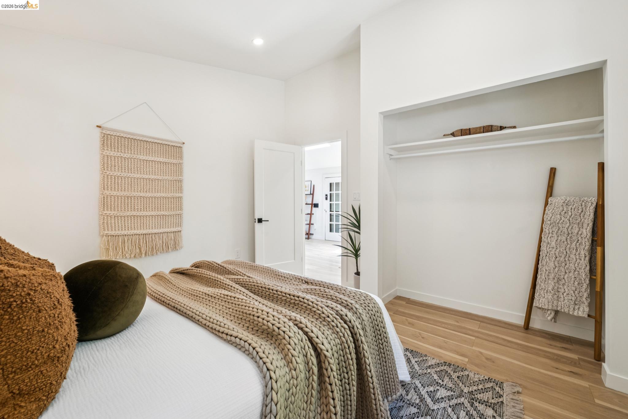 6400 Pinehaven Road Oakland, CA 94611 - Photo 46 of 78 Bedroom featuring light wood-finish flooring, recessed lighting, and a spacious open closet with shelving and hanging rods