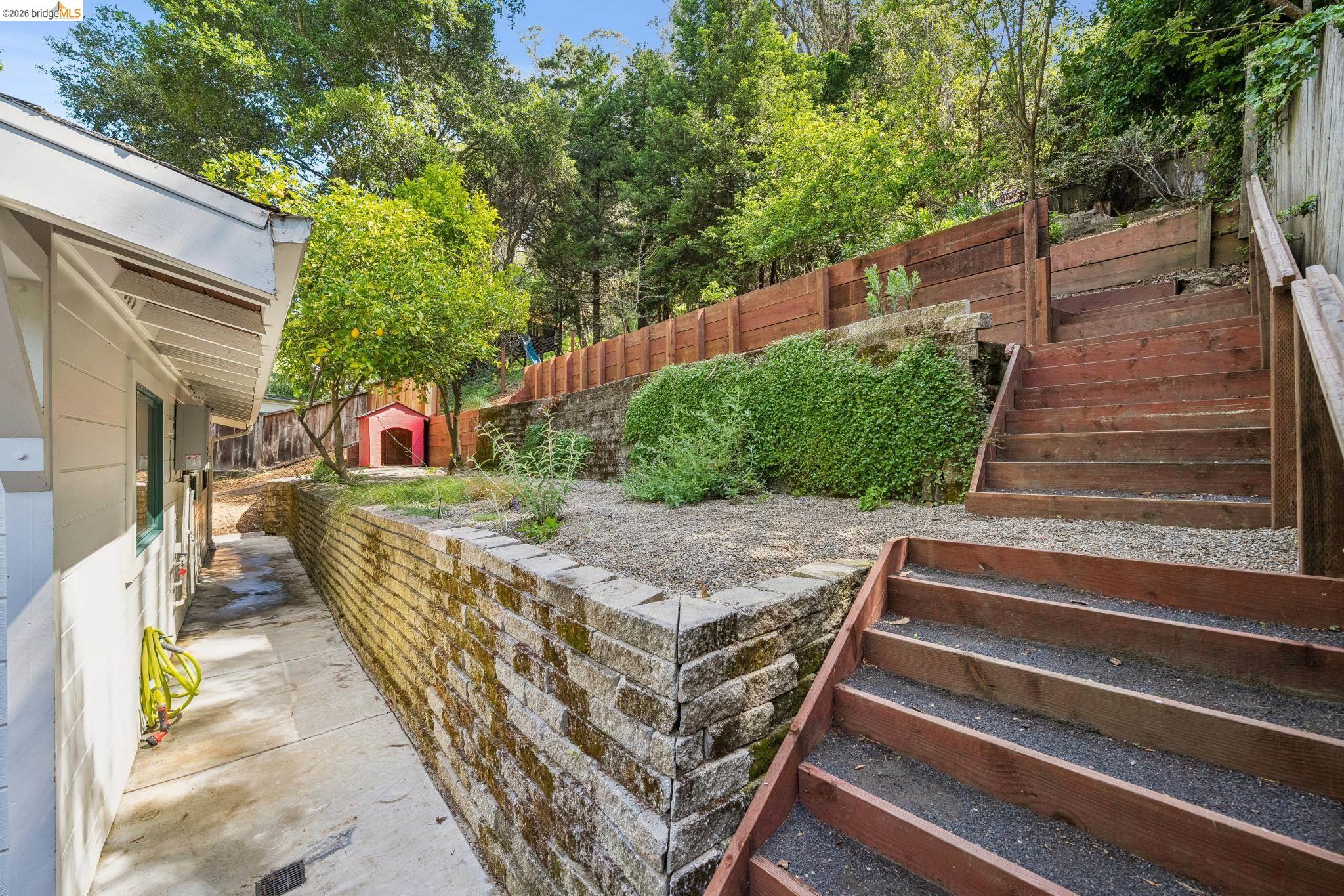 6400 Pinehaven Road Oakland, CA 94611 - Photo 48 of 78 Tiered backyard featuring natural stone retaining walls and wood steps