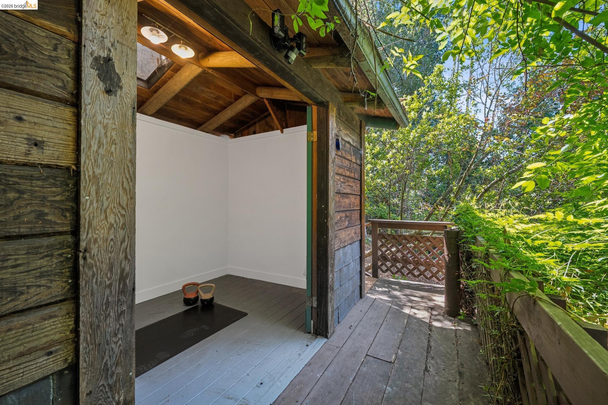 6400 Pinehaven Road Oakland, CA 94611 - Photo 58 of 78 Wood-paneled outbuilding featuring a white interior, exposed wood ceiling beams, and a skylight