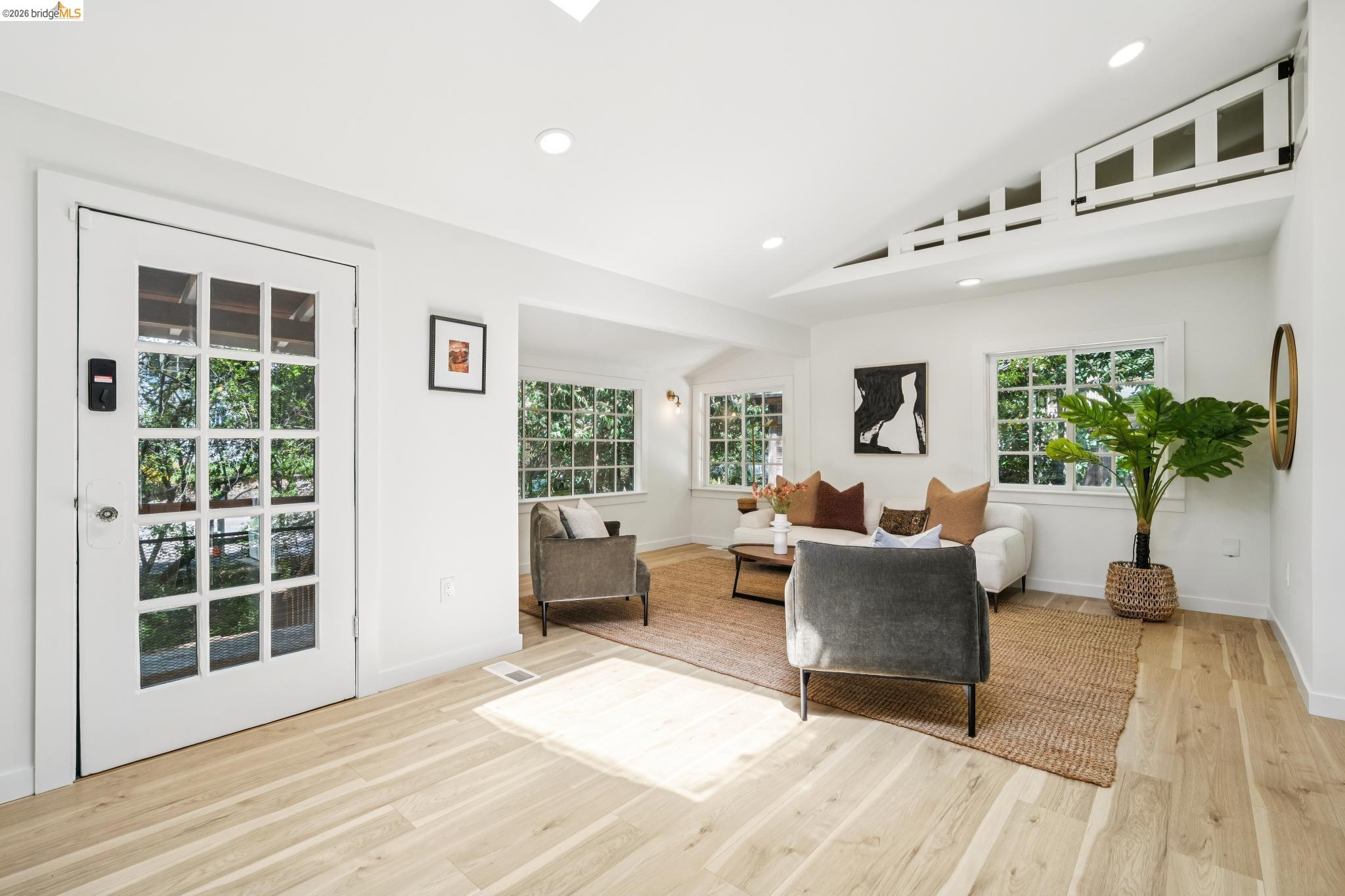 6400 Pinehaven Road Oakland, CA 94611 - Photo 7 of 78 Bright living space featuring natural wood-finish flooring, recessed lighting, and a vaulted ceiling with transom windows