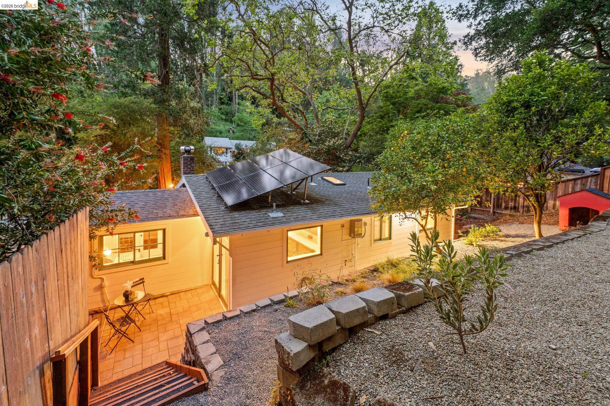 6400 Pinehaven Road Oakland, CA 94611 - Photo 74 of 78 Exterior residence featuring solar panels, a gabled roof, and light-toned siding