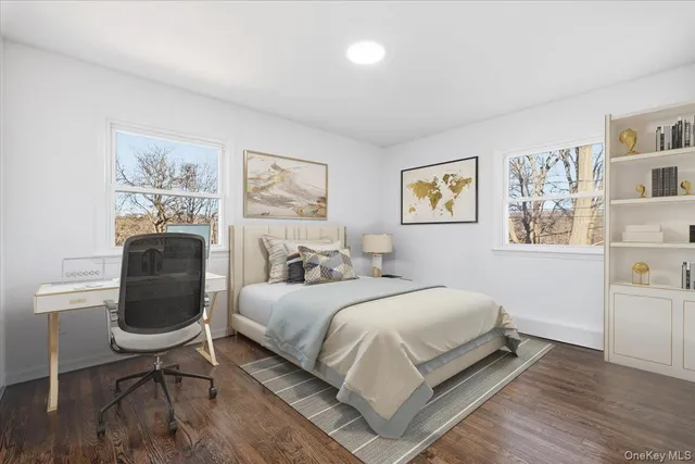 a bedroom with a bed a bookshelf and painting on the wall