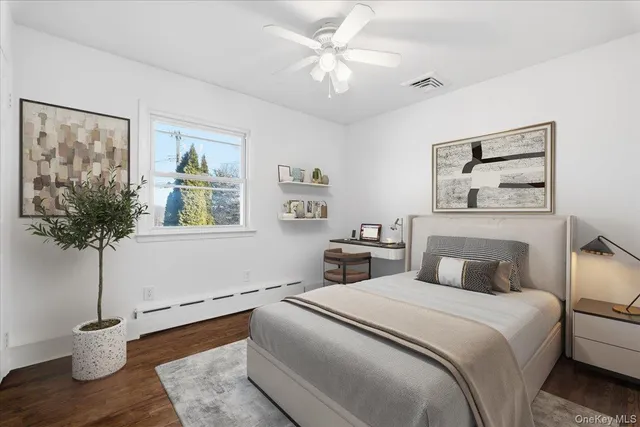 a bedroom with a bed and a potted plant