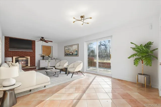a living room with furniture a chandelier and a window