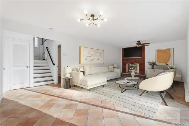 a living room with furniture and a ceiling fan