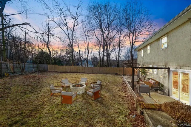 a backyard of a house with table and chairs