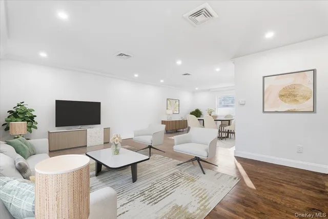 a living room with furniture a rug and a flat screen tv