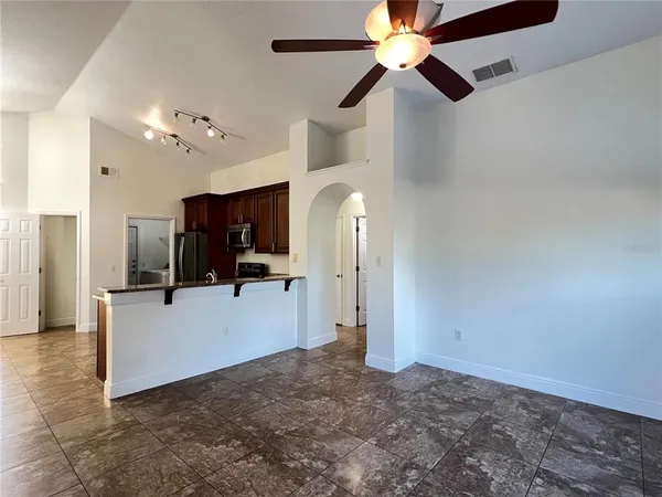 a view of a kitchen with a sink and a ceiling fan