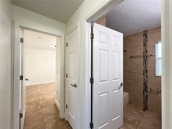 a view of a bathroom with a shower and a sink