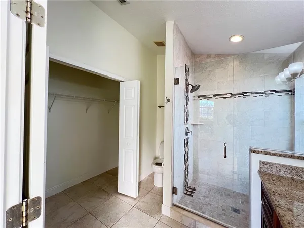a bathroom with a granite countertop shower mirror and a sink