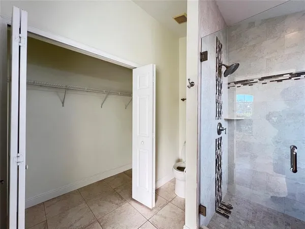 a bathroom with a glass shower door