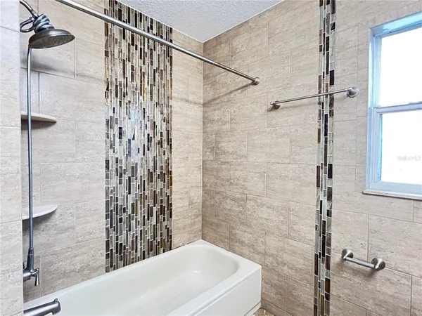 a bathroom with a bathtub and shower