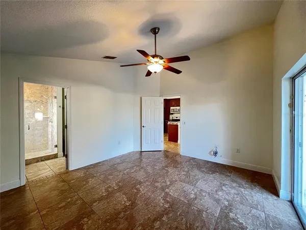 a view of room with a ceiling fan