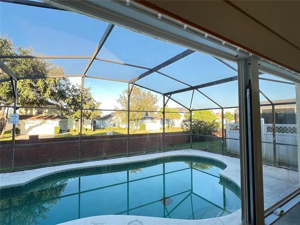 a view of a room with window and wooden floor