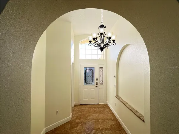 a view of a hallway with wooden floor and a dining room view