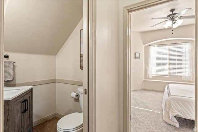 345 North 2450th Street East, Unit 152 St. George, UT 84790 - Photo 15 of 40 Ensuite bathroom featuring ceiling fan, vanity, and light carpet