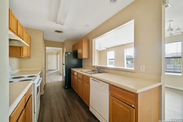 a kitchen with a stove a sink and a refrigerator