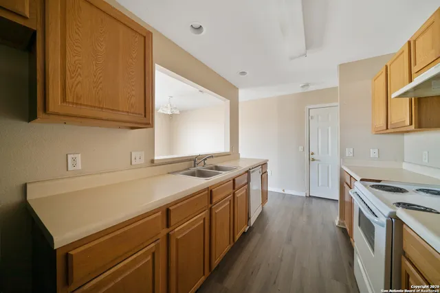 a kitchen with a sink stove and cabinets