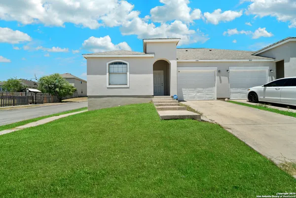 a front view of a house with a yard