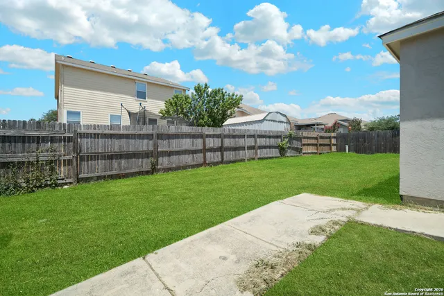 a view of a garden with a building in the background