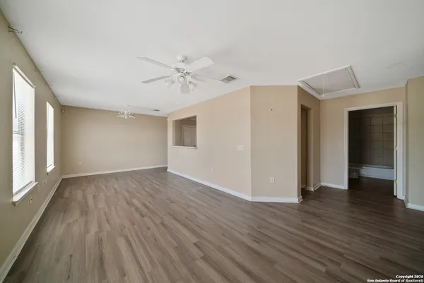 a view of an empty room with wooden floor