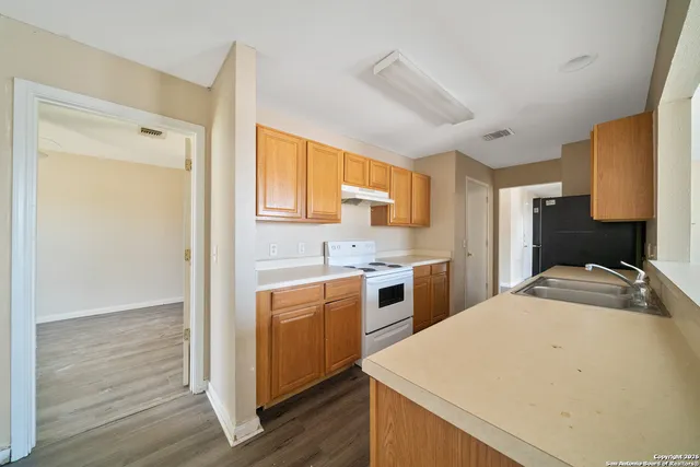 a kitchen with a sink a stove and refrigerator