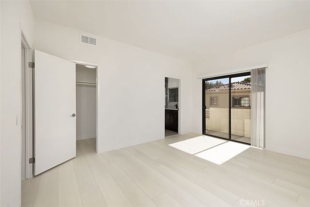 a view of a big room with windows and closet