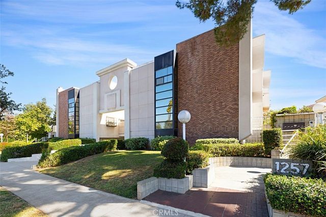 a front view of a building with garden