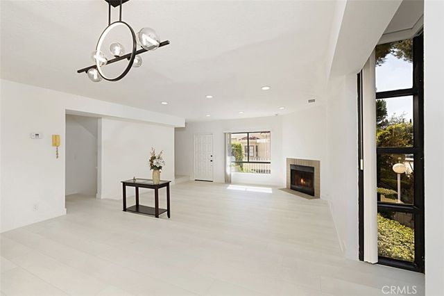 a view of a livingroom with furniture cabinet and mirror
