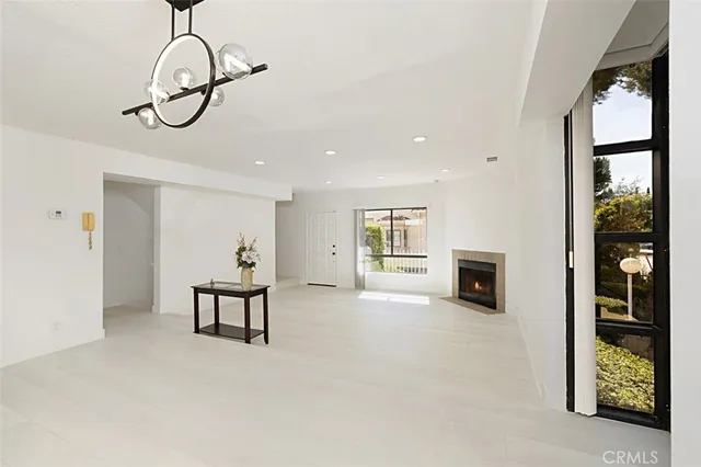 a view of a livingroom with furniture cabinet and mirror