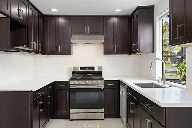 a kitchen with a sink and a stove