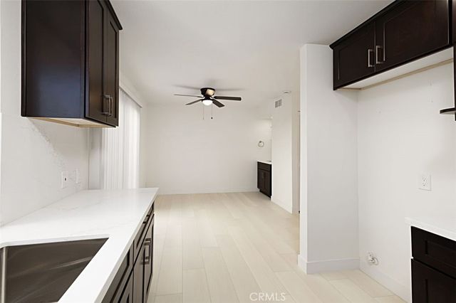 a view of a kitchen with white cabinets