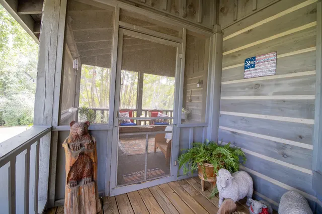 a dining room with furniture a chandelier and wooden floor
