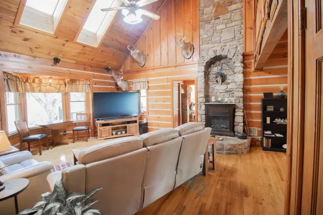 a bedroom with a bed and a flat tv screen on wall
