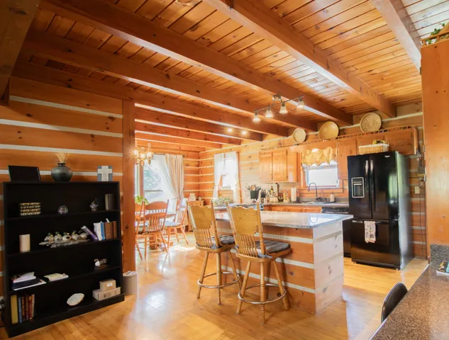 a kitchen with refrigerator and cabinets