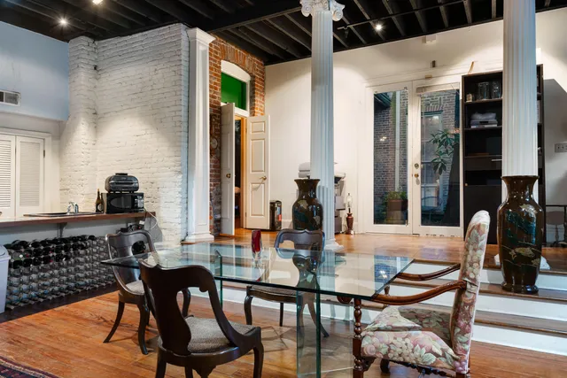 a dining room with furniture and wooden floor