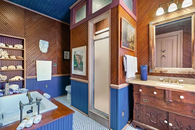 a bedroom with a bed wooden floor and window