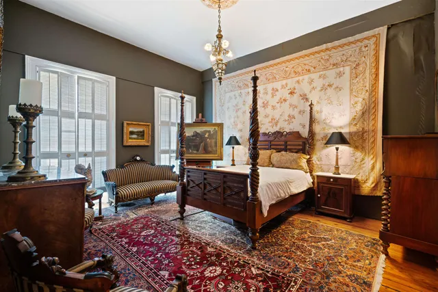 a bedroom with a bed a couch and dresser