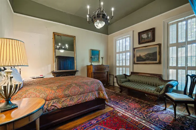 a living room with fireplace furniture and a large window