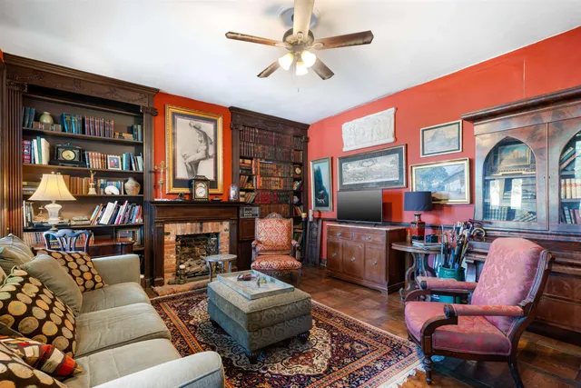 a living room with furniture a workspace and a window